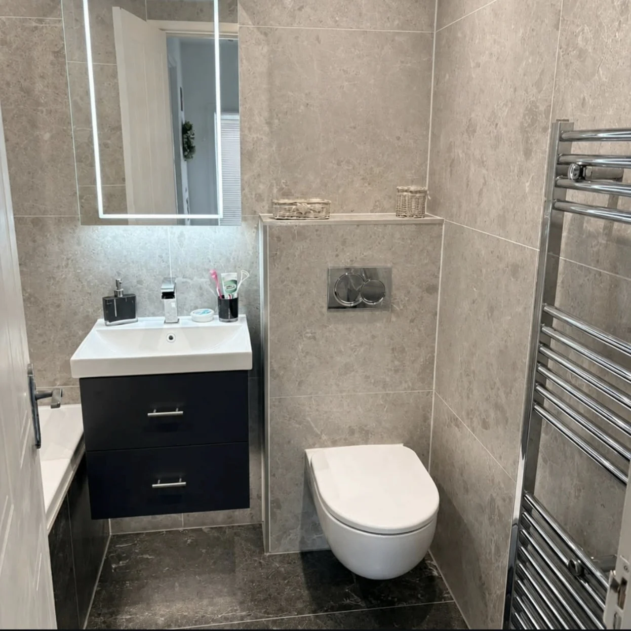 Stone and charcoal bathroom with vanity and wall-hung toilet