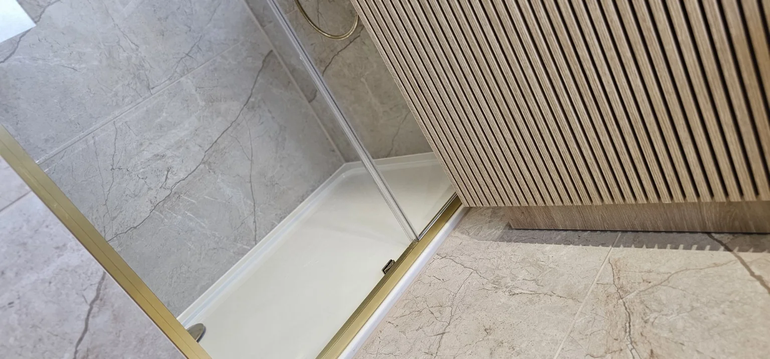 Brushed gold shower screen and fluted vanity detail